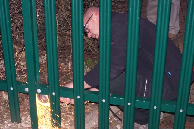 EDO Staff cut through their own fence to get to work
