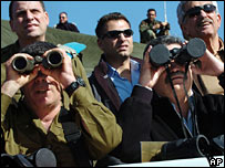 Amir Peretz with lense caps on his binoculars