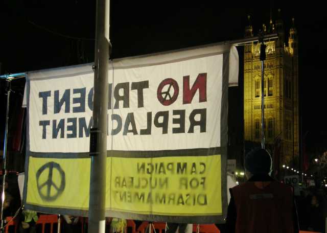 The backdrop to the stage faces the architecture of the Palace of Westminster