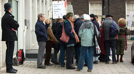 Activists gather outside the Football Association headquarters in Soho