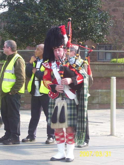 a piper leading the march