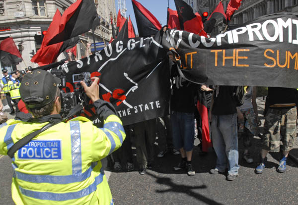 Police photographer in action on march