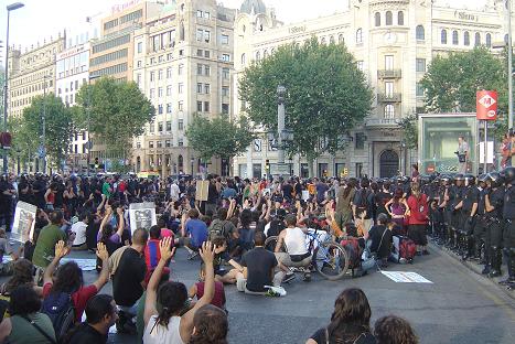 part of the crowd surrounded by lines of cops