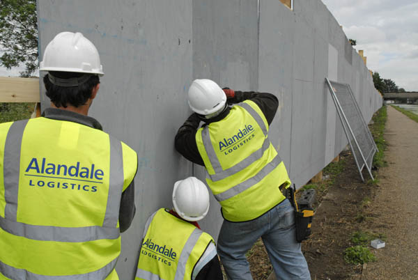 Workers erecting hordings which will surround the Olympic construction site
