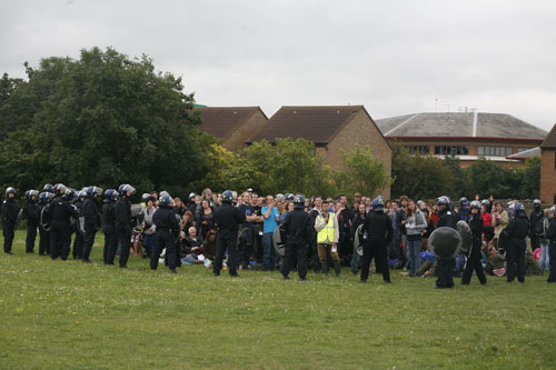 A group of protesters penned in by riot police