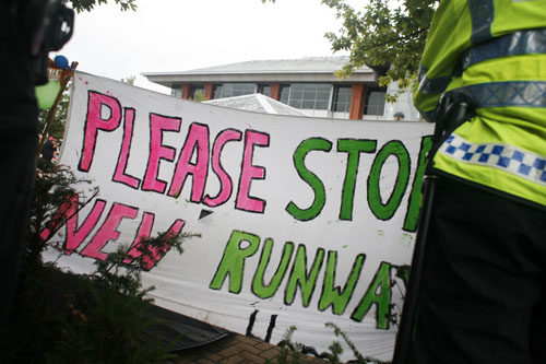 Banners going up surrounded by police