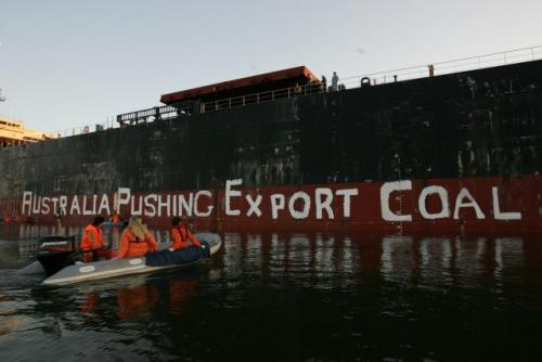 Greenpeace activists paint "Australia Pushing Export Coal"