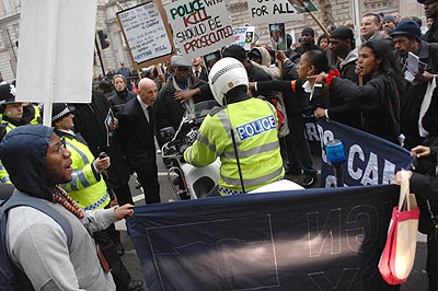 Moronic cop holds up the march...