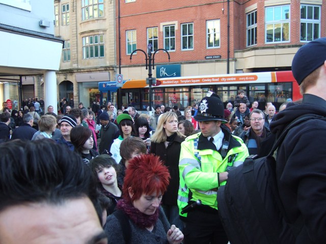 ...but passing shoppers are fascinated and a large crowd gathers