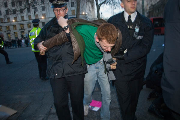 A protestor is painfully removed