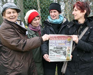 Cheeky women pose with Indy at camp