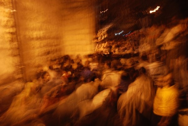 Crowds surge around the bodies