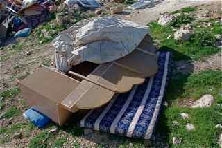 family out side their emergency tent,