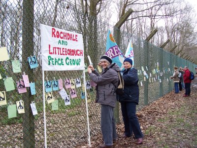 Rae Street and Mai Chatham fix the doves to Aldermaston's fence