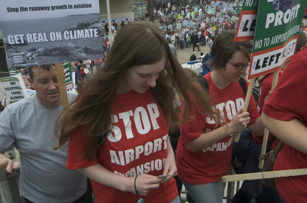 Protesters climb the footbridge from Hatton Cross to the start of the march