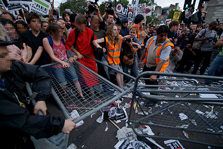 The crowd lose patience and tear down the barriers