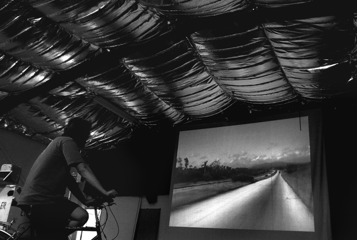 UK, London. Oval. Climate camp caravanners watching cycle-powered cinema.