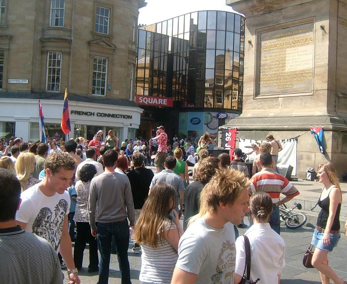 People at the street celebration enjoy the sunshine and the music