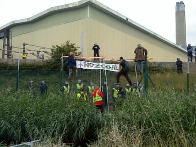 No 2 Coal banner unfurled at electric fence of Kingsnorth
