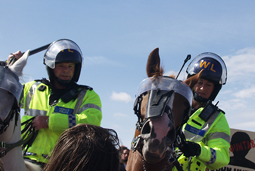 Lashing out with baton and crop in middle of march