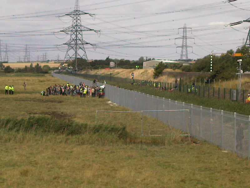 photo showing police, protestors and both fences