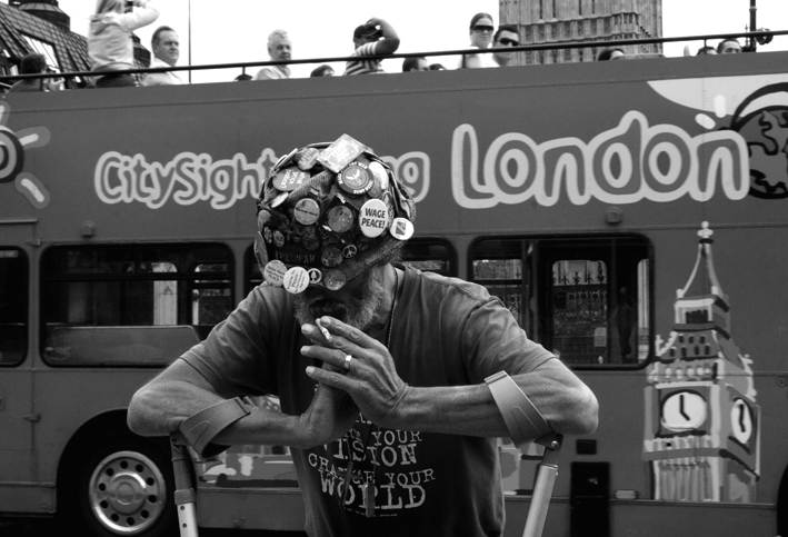 UK, London. Brian Haw pauses for thought as a tourist bus rolls past. 2008