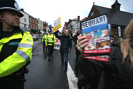 A police medic looks on.
