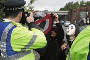 Protesters try to stop the Police from taking photographs