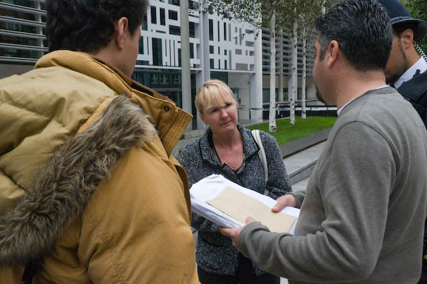 A Home Office official takes a letter and dossier