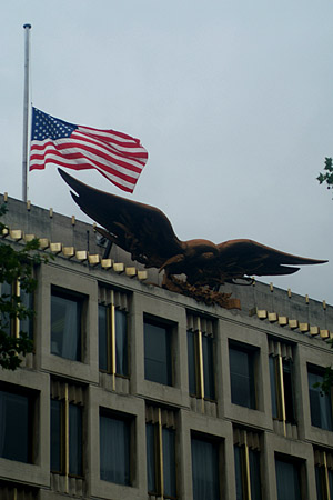 The US flag at half mast.