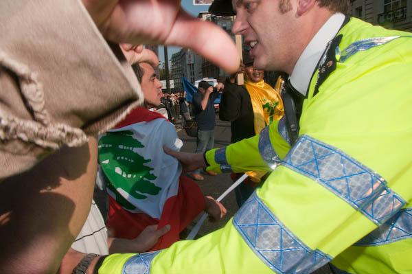 Police restrained marchers behind the tape