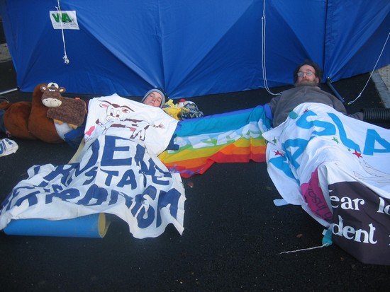 Protesters locked together with arm tubes