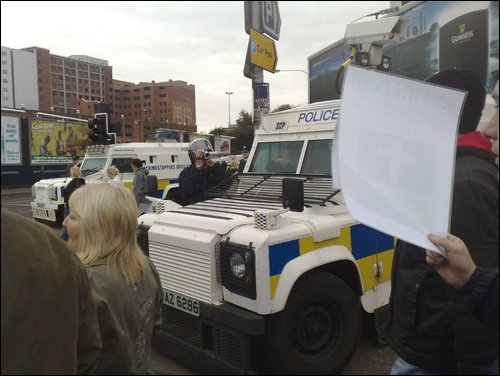 PSNI film the SF protest as Loyalists attack
