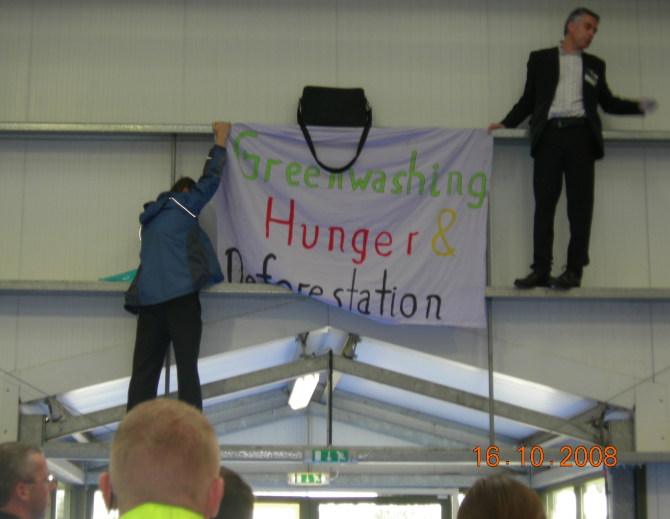Protestors hang banner inside the exhibition - it was here from 3.5 hours.