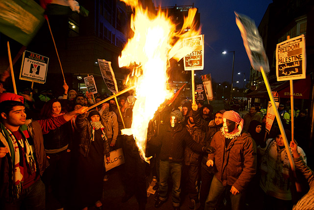 The Israeli flag burns outside the embassy.