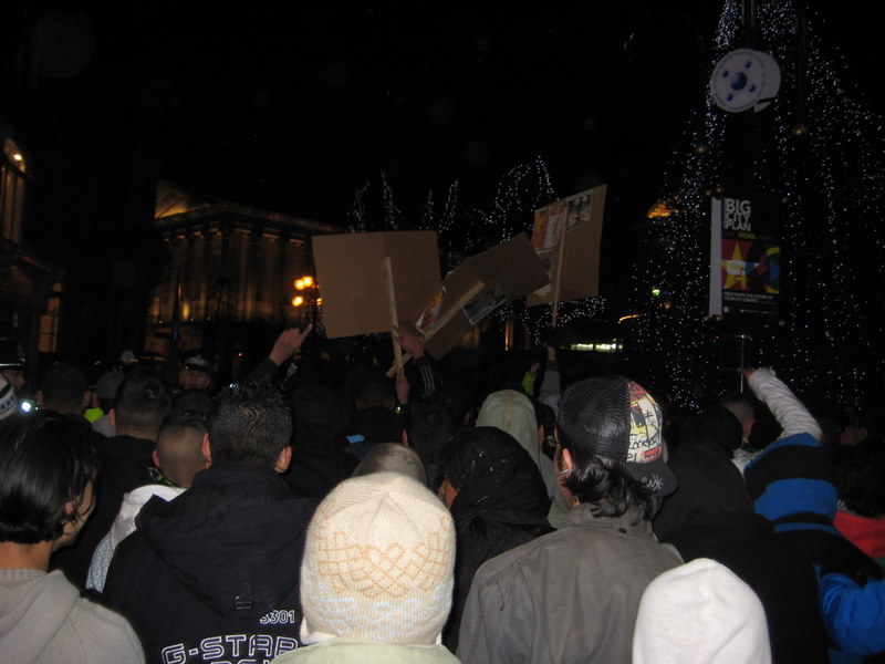 The outraged crowd moves off..