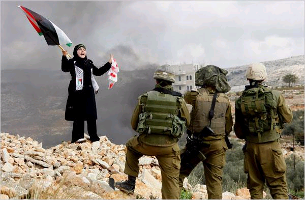 A Palestinian in front of Israeli soldiers during a protest in the West Bank