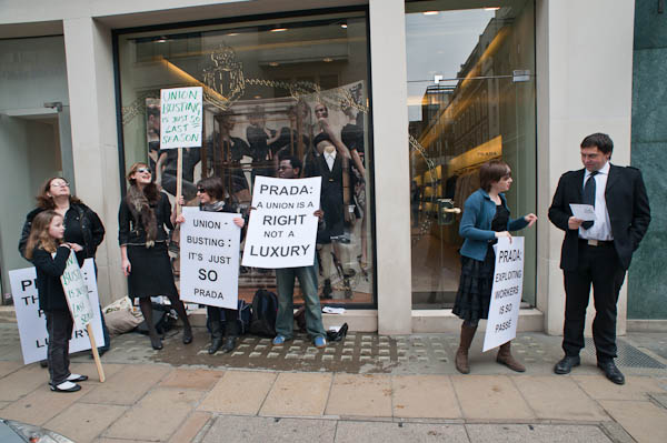 A Prada employee reads the leaflet