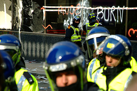 Officers photograph the damage.
