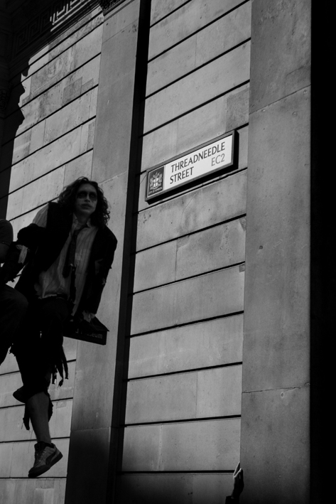 01.04.09 - G20 demonstrations. Demonstrator up lamp-post outside Bank of Eng