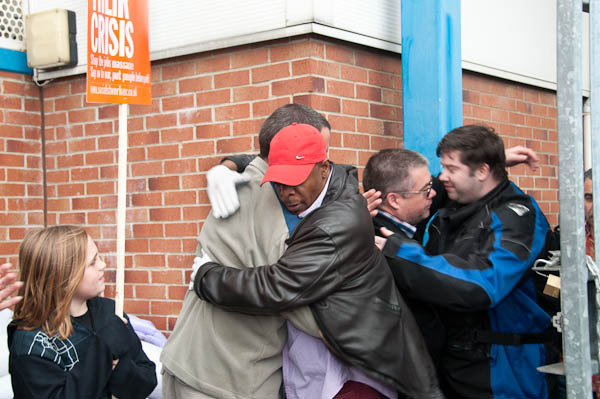 Fraternal embraces as the occupiers emerge