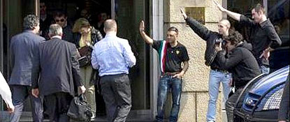 fascist activists give Nazi salutes to speakers arriving at the meeting in Milan