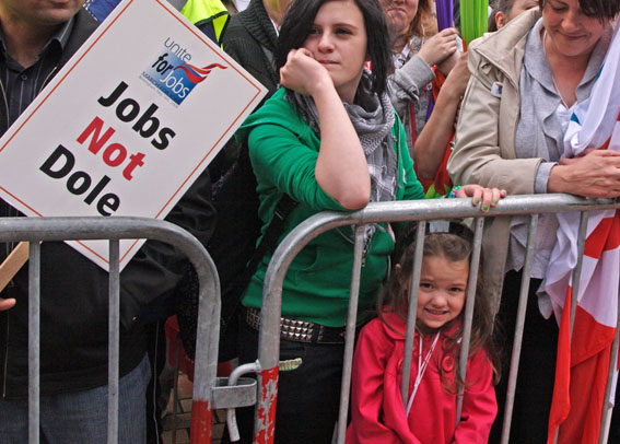Child looking through bars of crush barriers at rally point