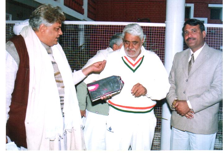 Naresh Kadyan presenting his book to Speaker Dr. R.S. Kadian..