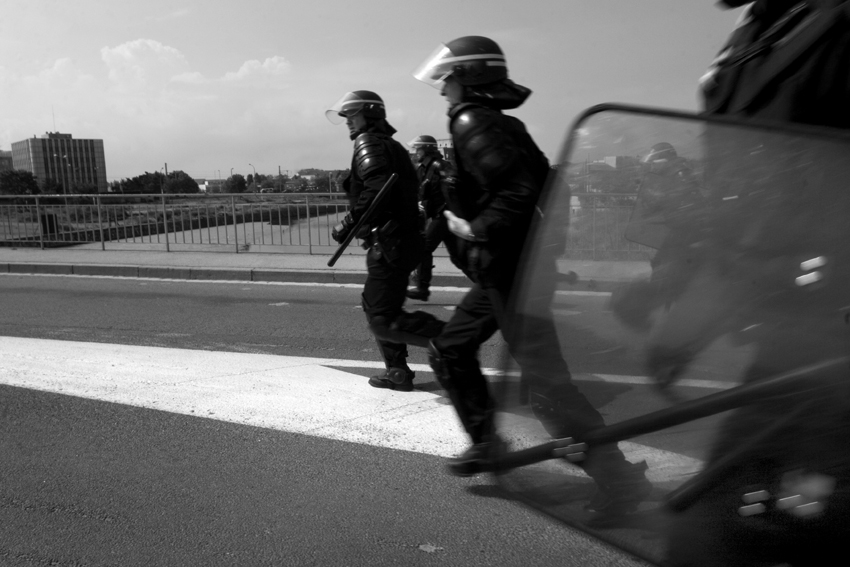 Calais. Riot police rush to the No Border demo as it moves through the town.