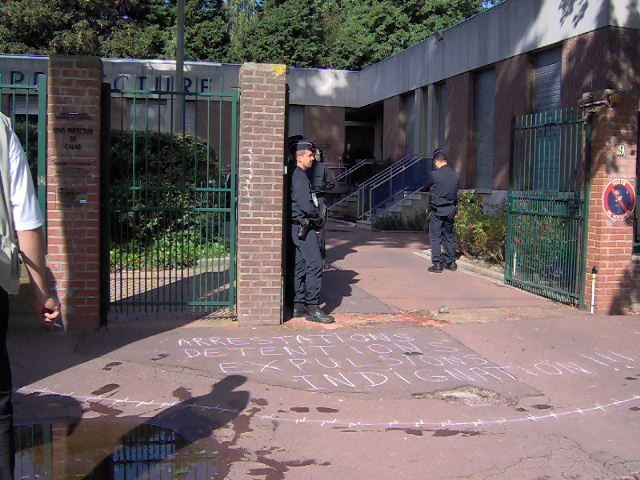 chalked messages at entrance to police station