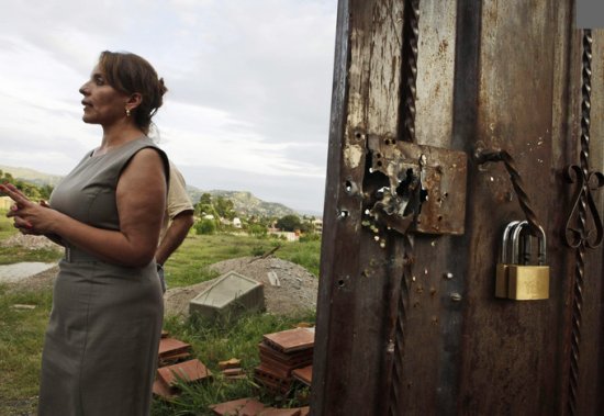 Zelayas wife shows Army bullet holes at her home