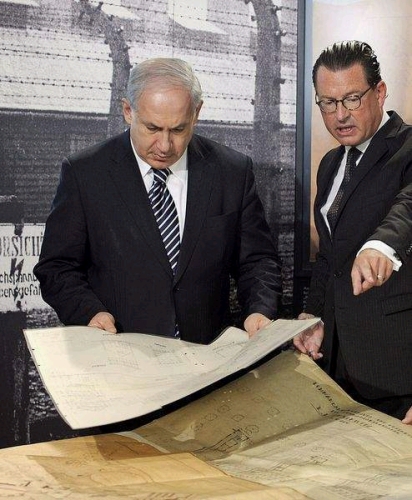 Israeli Prime Minister examines blueprints of the Auschwitz concentration camp