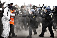 Danish riot police beat protesters
