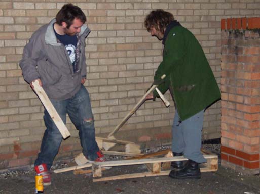 The wrecking crew! Breaking wood for burning.